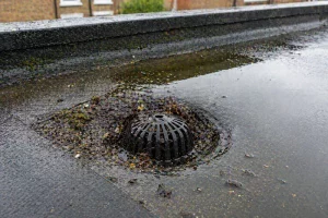 Blocked flat roof drain causing ponding water