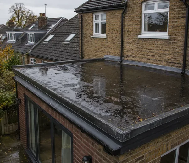 Residential property in London with flat roof holding rainwater after heavy rain