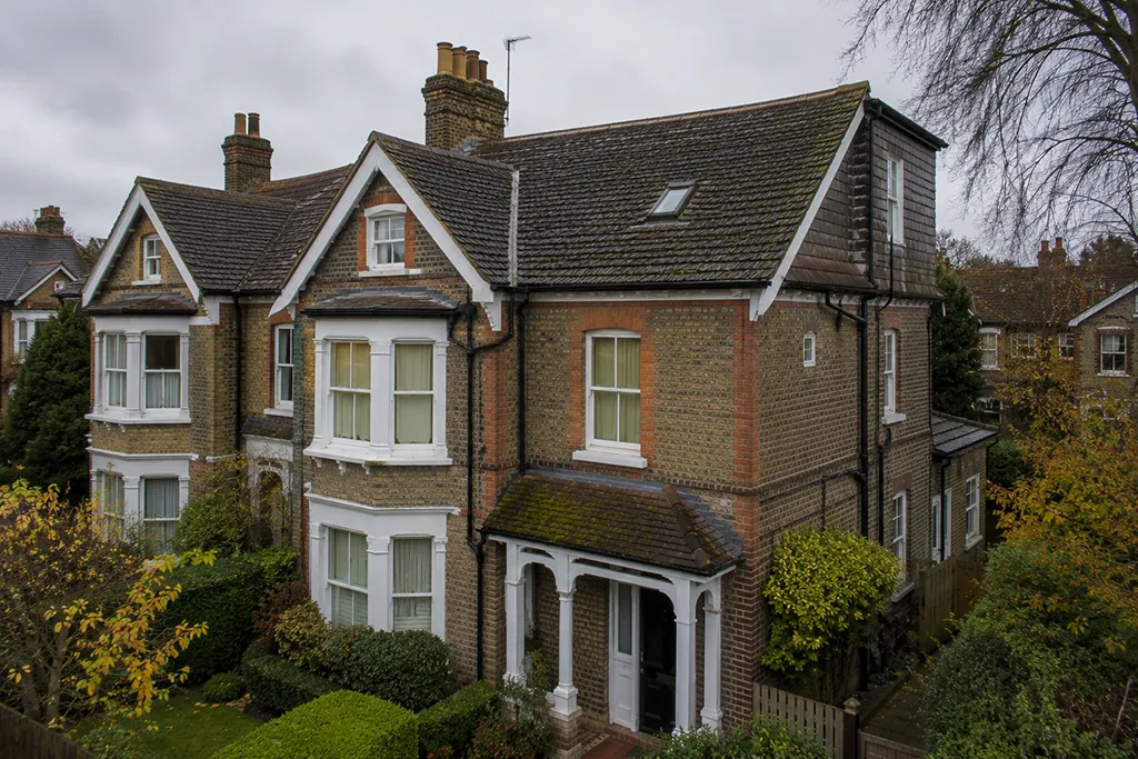 Residential house in London with pitched roof shown in late autumn context