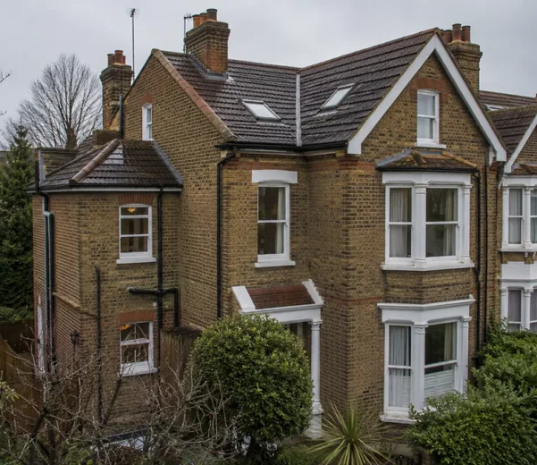 Residential house in London with pitched roof and roof details shown in context